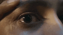 a close up of a woman 's eye with a tear coming out of it