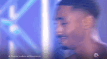 a blurry picture of a man 's face with the words american ninja warrior on the bottom right corner .