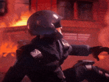 a man in a helmet stands in front of a fire in a dark room