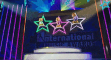 three chipmunks are dancing on a stage in front of a sign that says international music awards