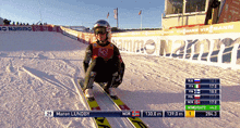 a person on skis with the name mareen lundby on the bottom of the screen