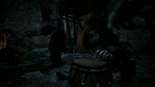 a man is playing a drum in the dark