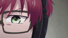 a close up of a person 's eye with green eyes and red hair