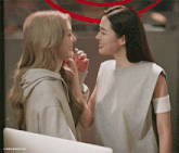 two women are touching each other 's faces and the words lingermoifss are on the bottom