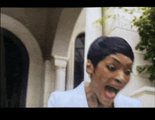 a woman with short hair is making a surprised face