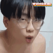 a young boy wearing glasses is making a funny face and looking at the camera .