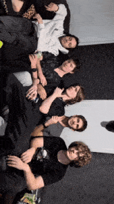 a group of young men are sitting on a couch with one wearing a shirt that says ' nc ' on it