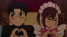 a boy and a girl making a heart with their hands