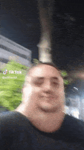 a man 's face is blurred in a tiktok video .