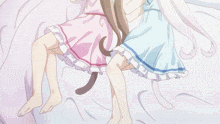 a couple of anime girls laying on a bed