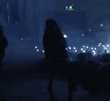a blurry picture of a man and woman hugging in a dark room