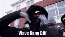 a man wearing a mask and gloves with the words wave gang diff on the bottom