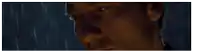 a close up of a man 's face with rain drops falling on it .