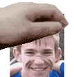 a close up of a person 's hand holding a man 's face .