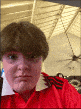 a person wearing a red shirt that says ' united ' on it