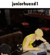 a man in a yellow tank top sits at a table with a black cat and the words juniorhuexd1 above him