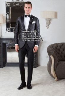 a man in a tuxedo stands in front of a couch and mirror