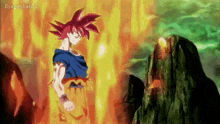 a cartoon character with red hair is standing in front of a mountain surrounded by flames .