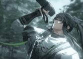 a man in a ponytail is holding a sword in his hand