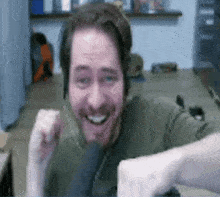 a man with a beard is wearing headphones and smiling .