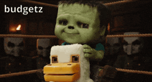 a green cartoon character is sitting on a stuffed animal with the word budgetz on the bottom right