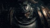 a close up of a robot with the letter t on it 's head