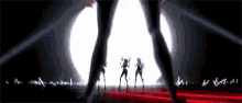 a group of women are dancing on a stage in front of a large light .