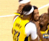 a basketball player wearing a yellow jersey with the number 32 on it