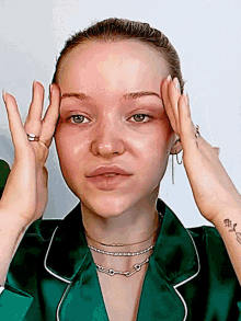 a woman in a green shirt has a tattoo on her wrist that says ' flowers '