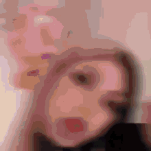 a blurred image of a person 's face with a pink background