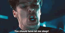 a close up of a man 's face with the words `` you should have let me sleep '' written on it .