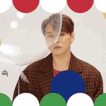 a man in a plaid jacket is standing in front of a balloon with chinese writing on it