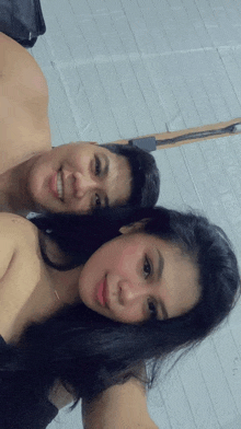 a man and a woman are posing for a picture and smiling