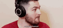 a man with a beard is wearing headphones and saying , `` mouthing butthole ! ''