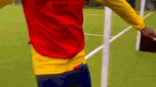 a man wearing a red and yellow vest that says ' ghana ' on it