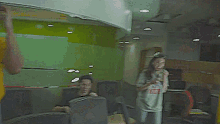 a man and woman are standing next to each other in a room .