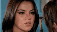 a close up of a woman 's face with a tear running down her cheek .