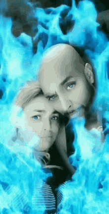 a man and a woman are surrounded by blue flames and smoke