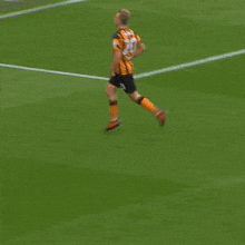 a soccer player with the number 20 on his jersey is running on the field