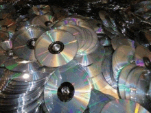 a pile of cd 's are stacked on top of each other .