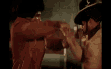 two men are standing next to each other in a room .