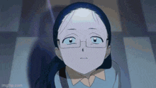 a close up of a girl wearing glasses making a face .