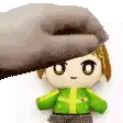 a person is holding a stuffed animal in their hand .