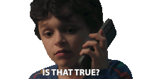 a young boy talking on a cell phone with the words " is that true " written below him