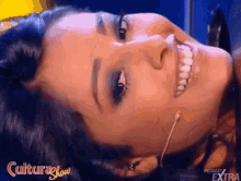 a close up of a woman 's face with the words culturashow written on the bottom