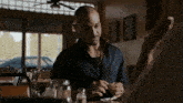 a man sitting at a table with a plate of food