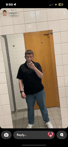 a man taking a picture of himself in a bathroom with the time 9:50 on his phone