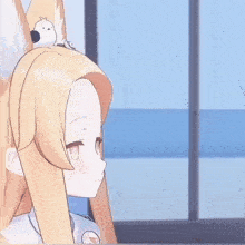a girl with a bird sitting on her head