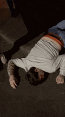 a person is laying on their back on the ground with smoke coming out of their mouth .
