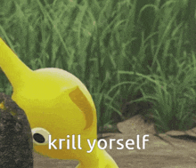 a yellow toy is standing in the grass with the words krill yourself below it